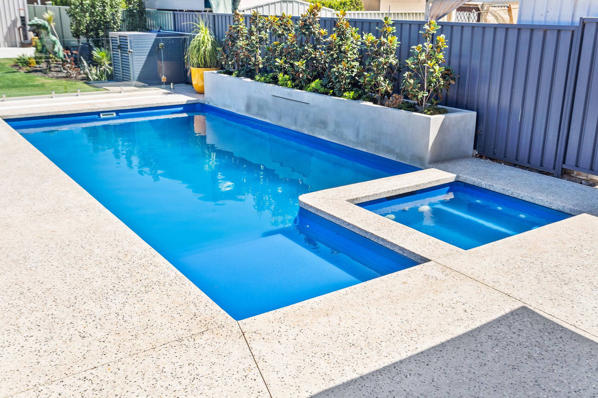 There is a Waterfall in the Middle of a Swimming Pool — Gibson Family Pools Pty Ltd In Taree, NSW