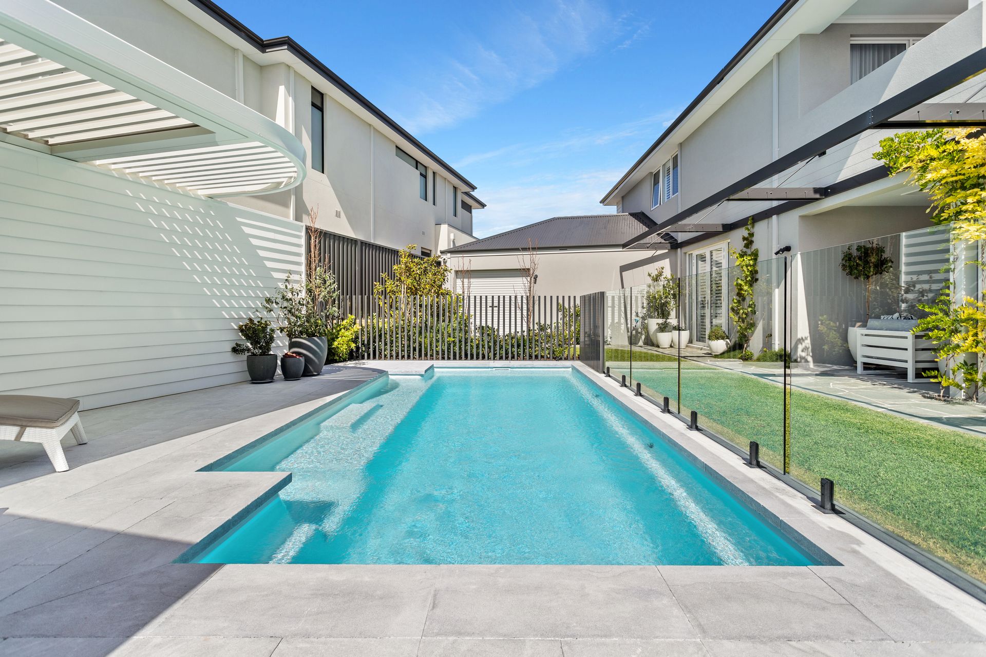 There is a Large Swimming Pool in Front of a House — Gibson Family Pools Pty Ltd In South West Rocks, NSW