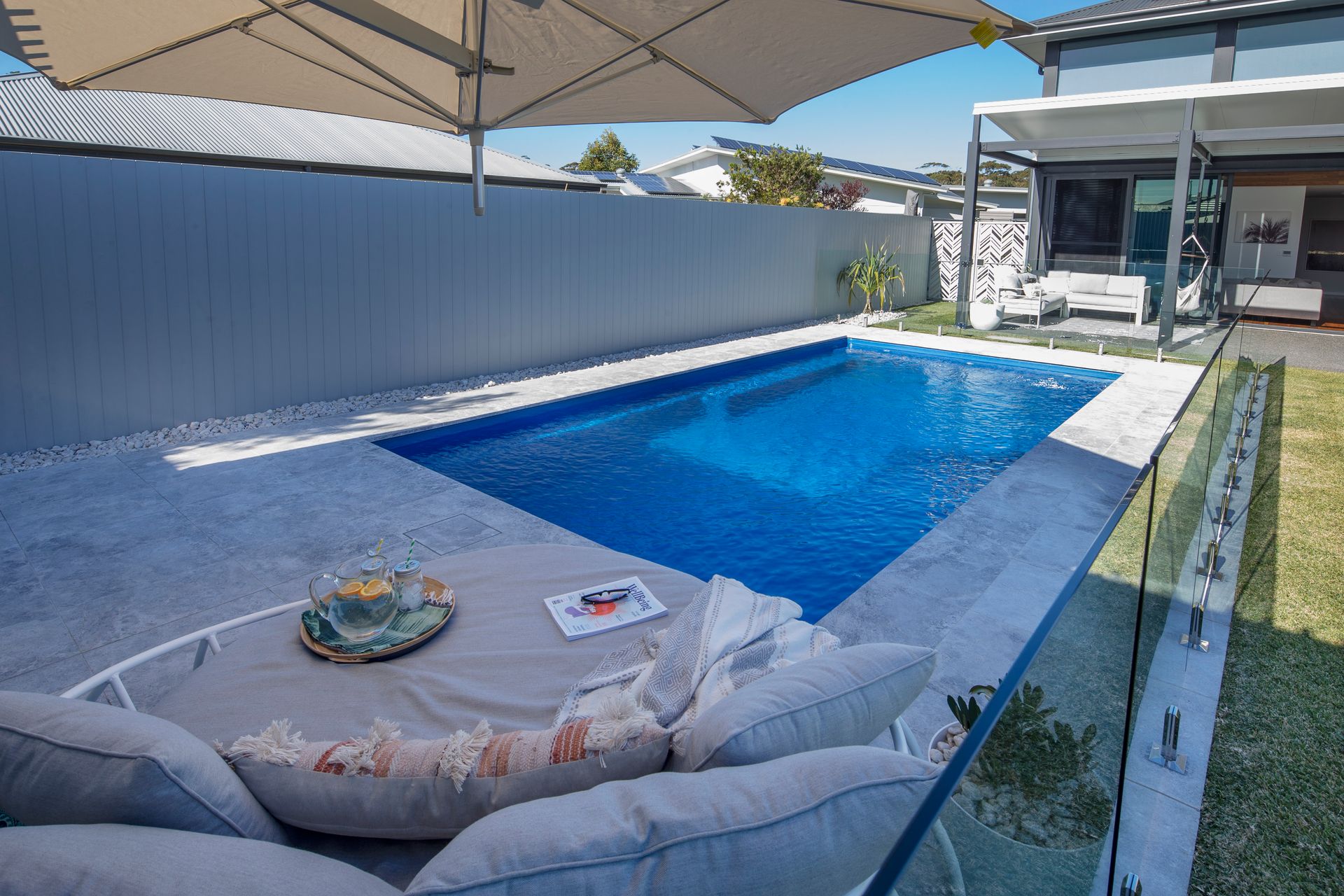 A Boy and a Girl Are Sitting on the Edge of a Swimming Pool — Gibson Family Pools Pty Ltd In Bulahdelah, NSW