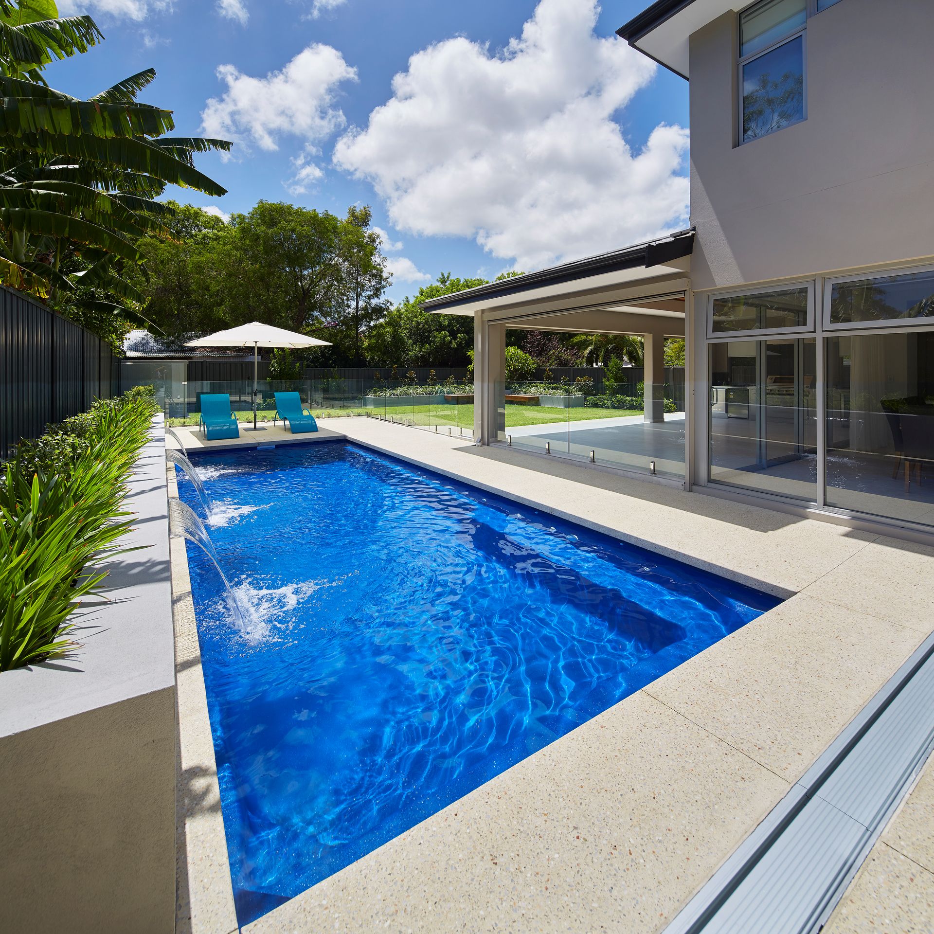 A Close Up of a Swimming Pool With a Curved Edge — Gibson Family Pools Pty Ltd In Forster, NSW