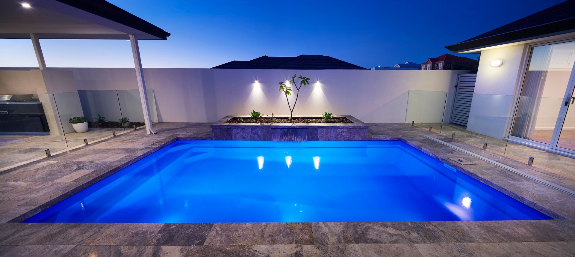 There is a Large Swimming Pool in Front of a House — Gibson Family Pools Pty Ltd In Laurieton, NSW