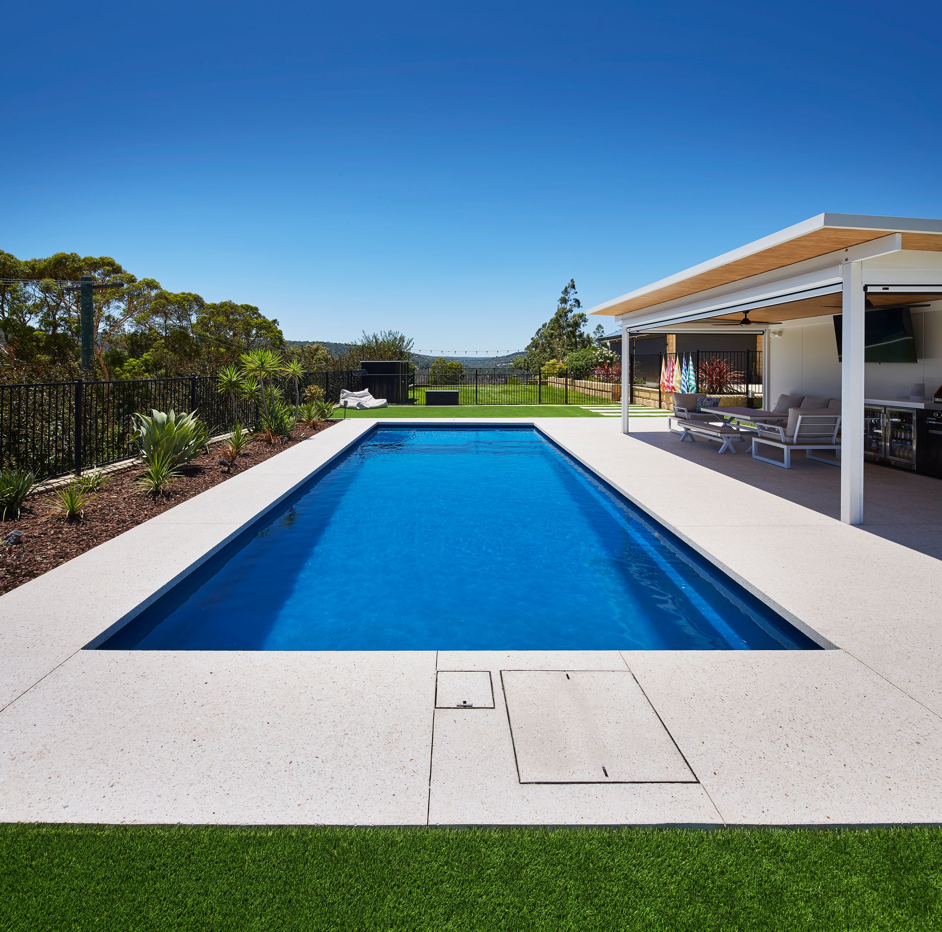 A Large Swimming Pool With Stairs Leading To It — Gibson Family Pools Pty Ltd In Port Macquarie, NSW
