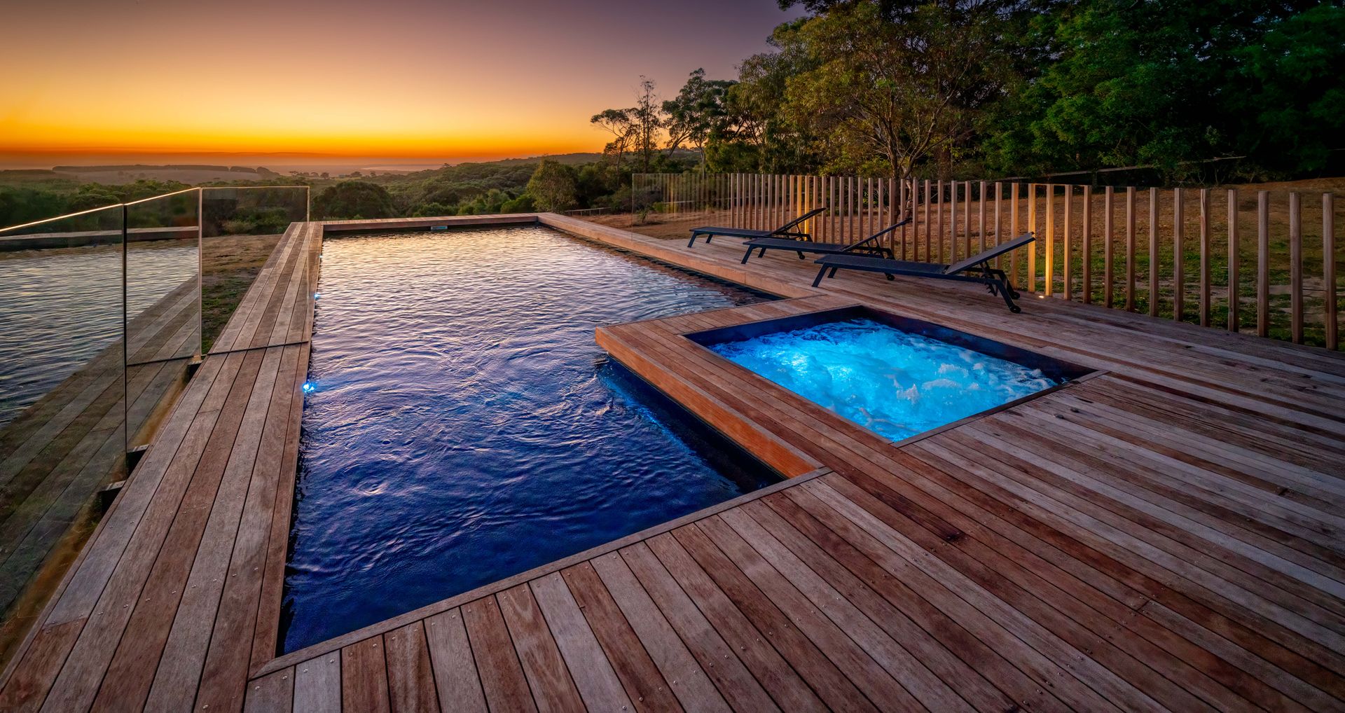 A Modern House With A Swimming Pool At Night — Gibson Family Pools Pty Ltd In Port Macquarie, NSW