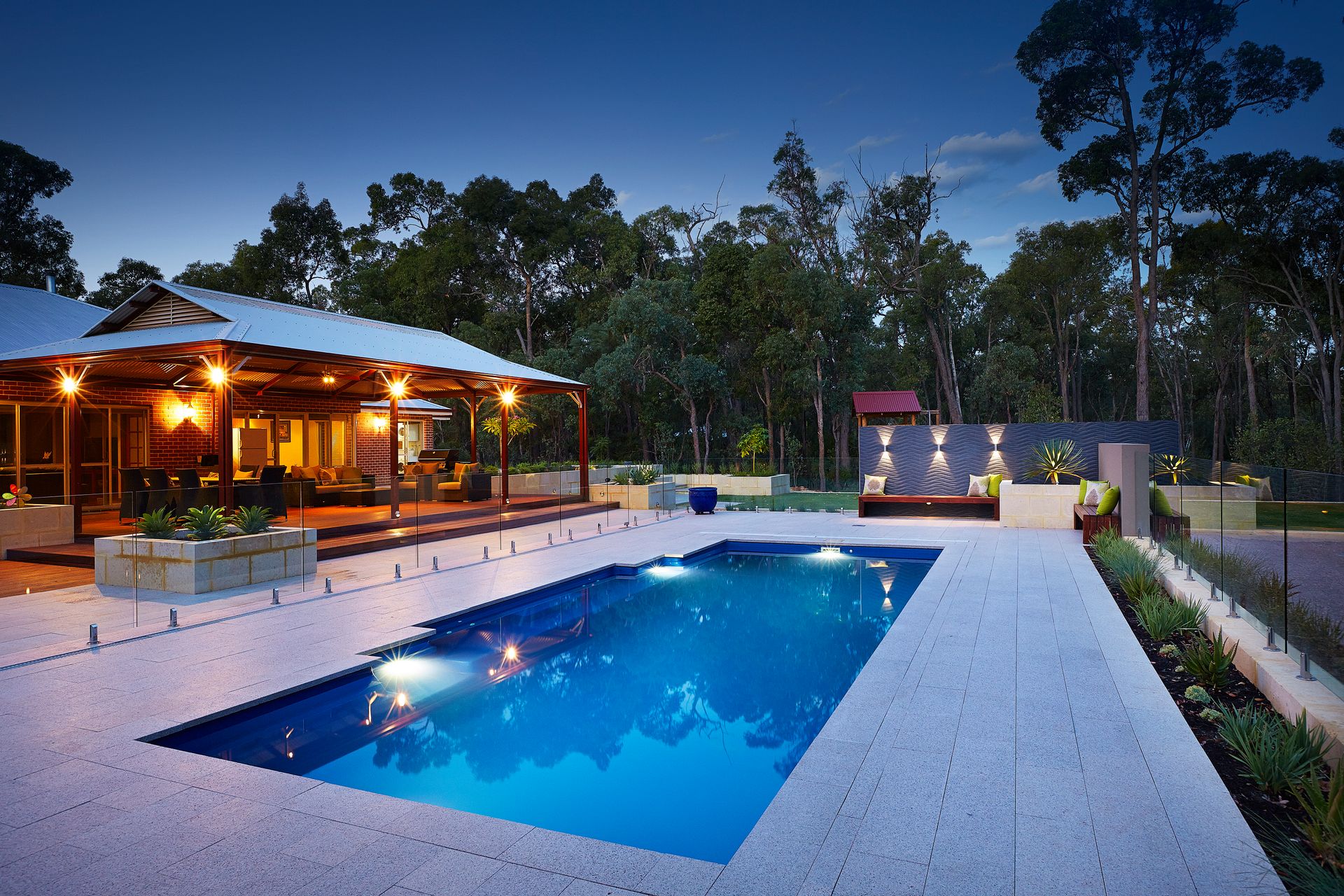 A House With a Large Swimming Pool in Front of It — Gibson Family Pools Pty Ltd In Laurieton, NSW