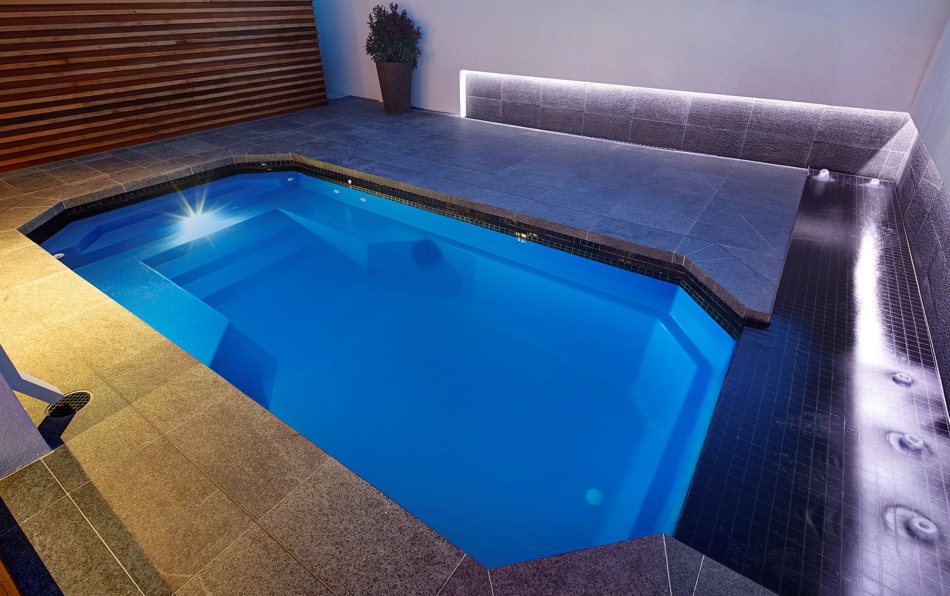 There is a Waterfall in the Middle of a Swimming Pool — Gibson Family Pools Pty Ltd In Wauchope, NSW