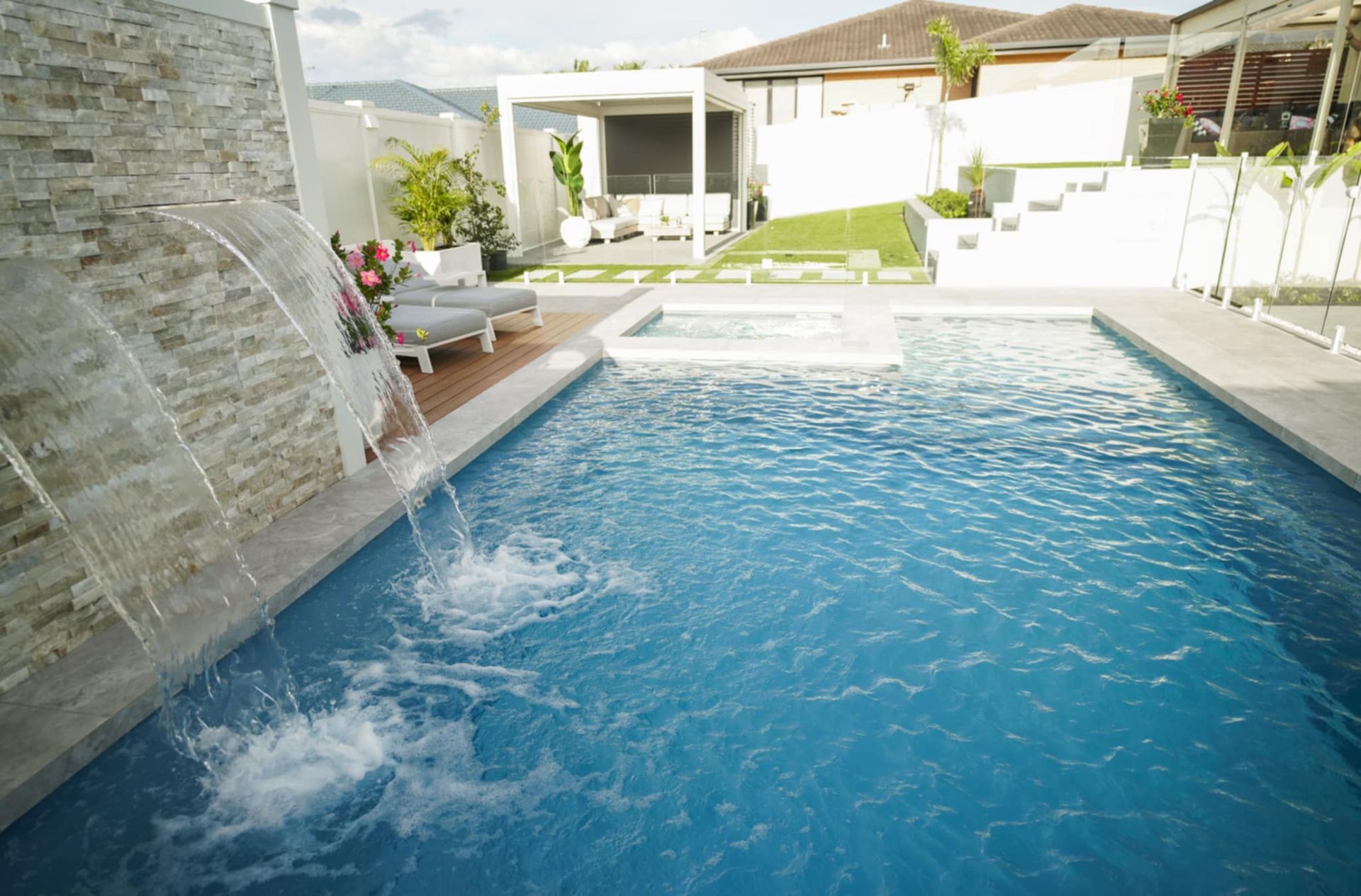 Modern backyard pool with a stone waterfall — Gibson Family Pools Pty Ltd In Port Macquarie, NSW