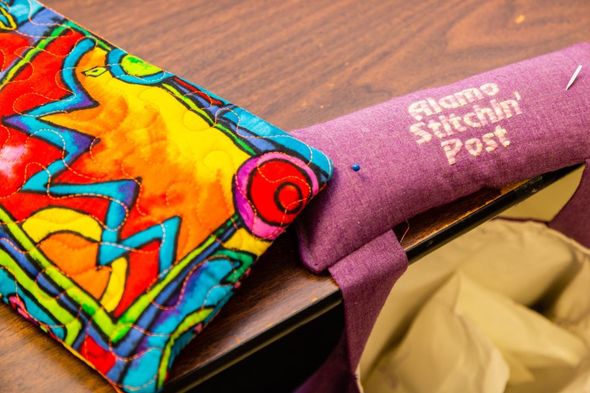 Colorful decorated graduation stole with “Grand Rapids Tech” text on a table