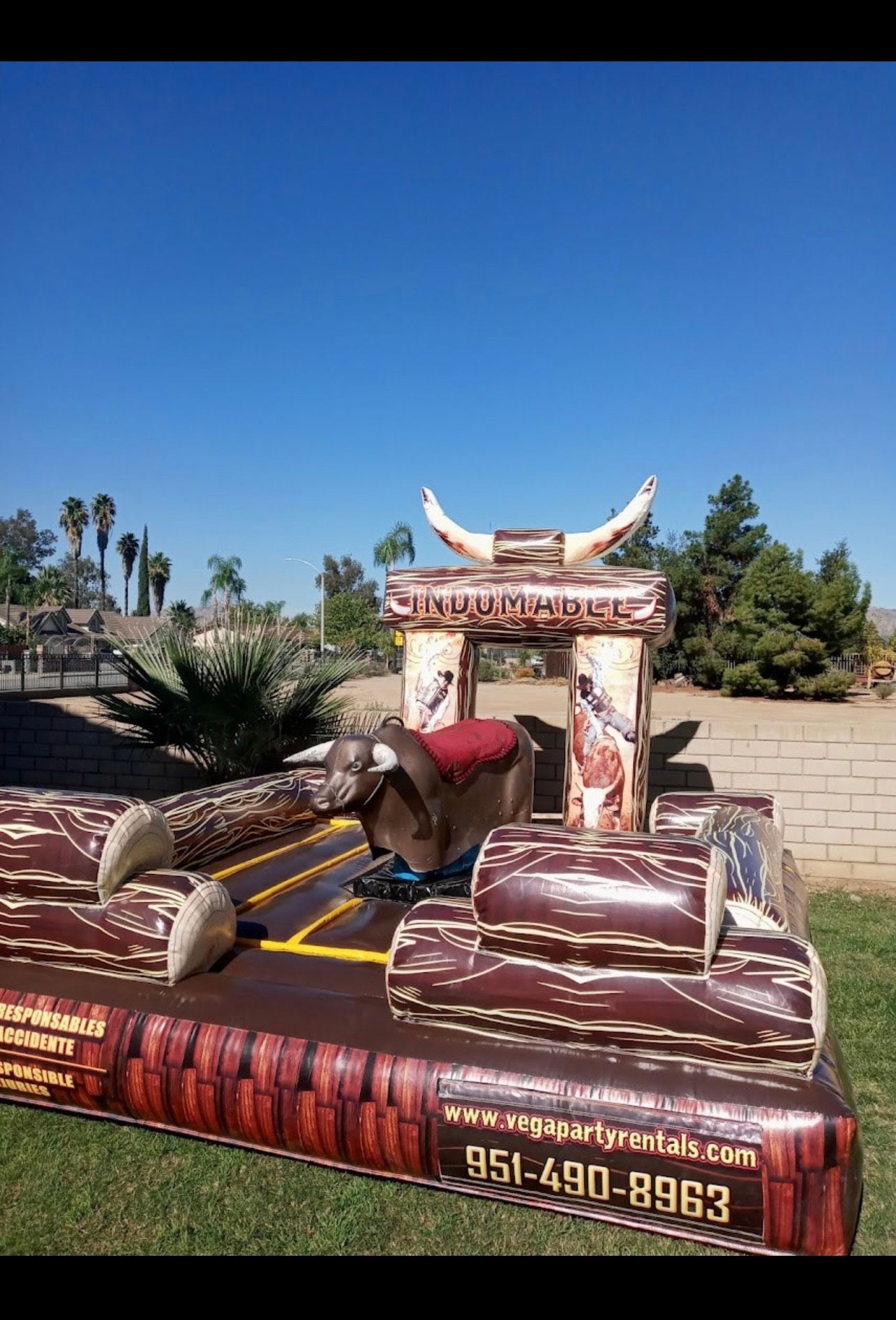 A man is riding a bull at a rodeo.