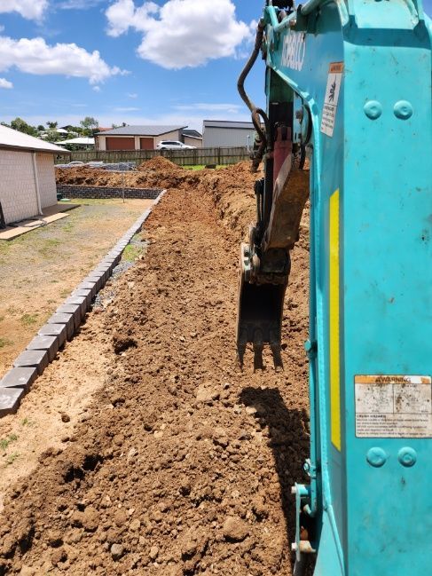 A Blue Excavator Is Digging A Hole In The Dirt — Rockyview Excavations In Rockyview, QLD