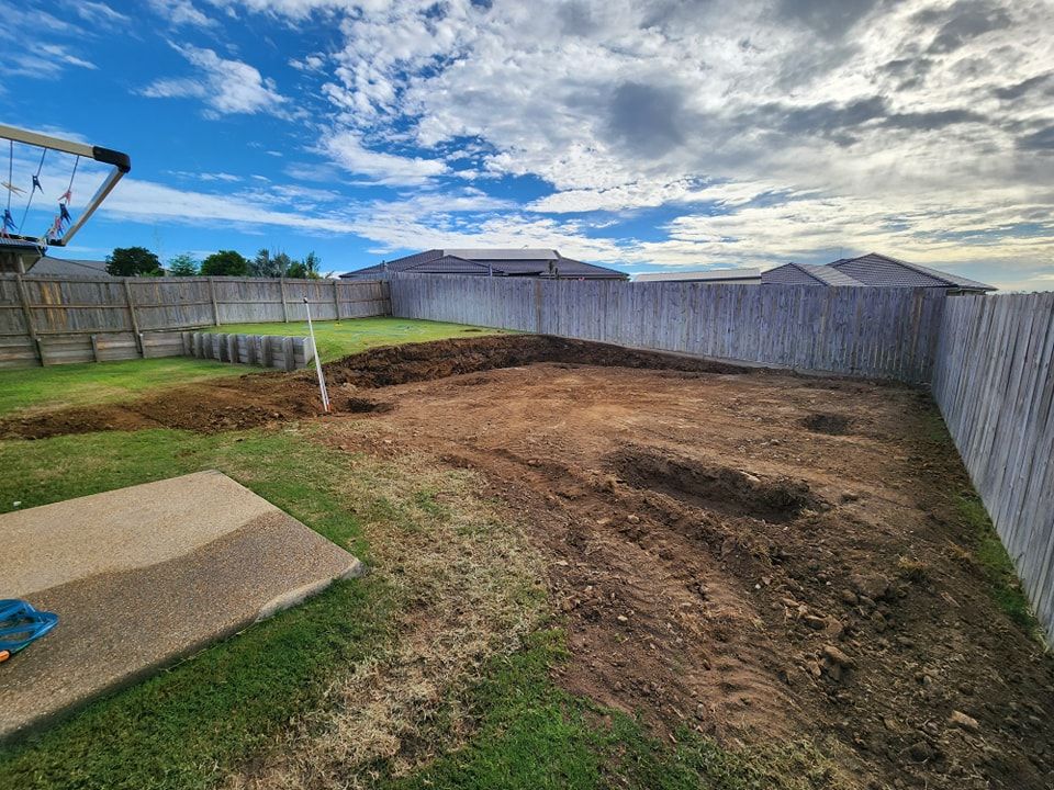 A Backyard With A Fence And A Swing Set In The Background — Rockyview Excavations In Rockyview, QLD