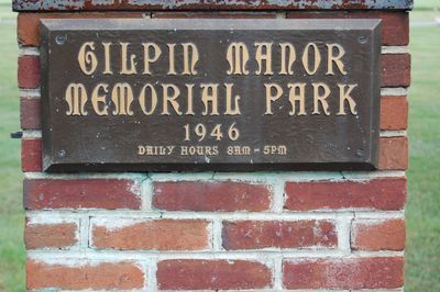 A brick sign reads 