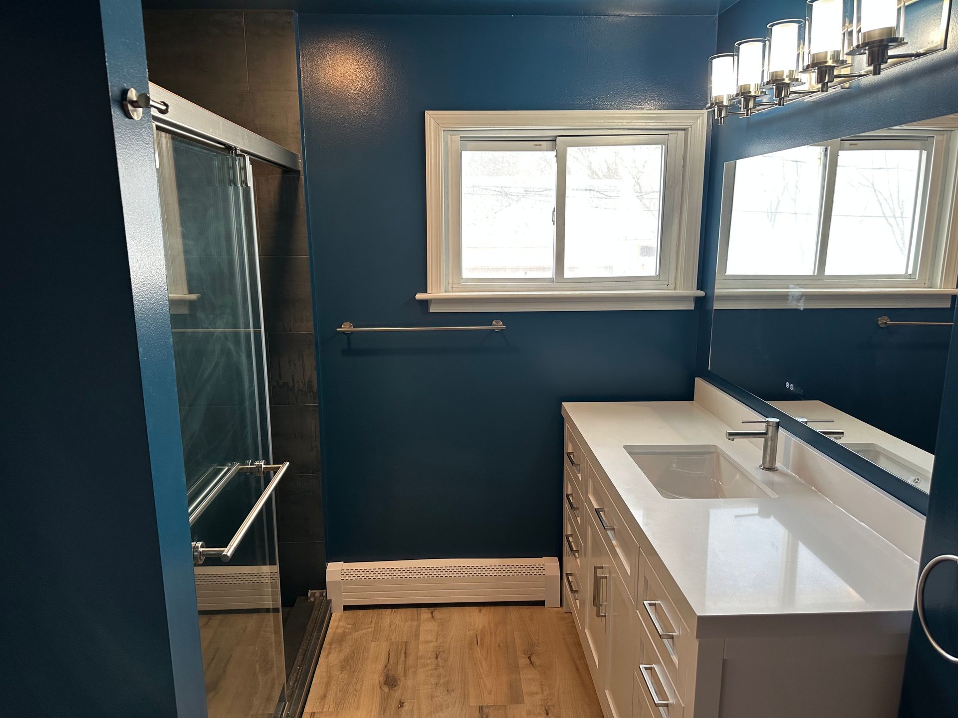 Small room with a window, built-in shelving, and a desk or counter along the wall.