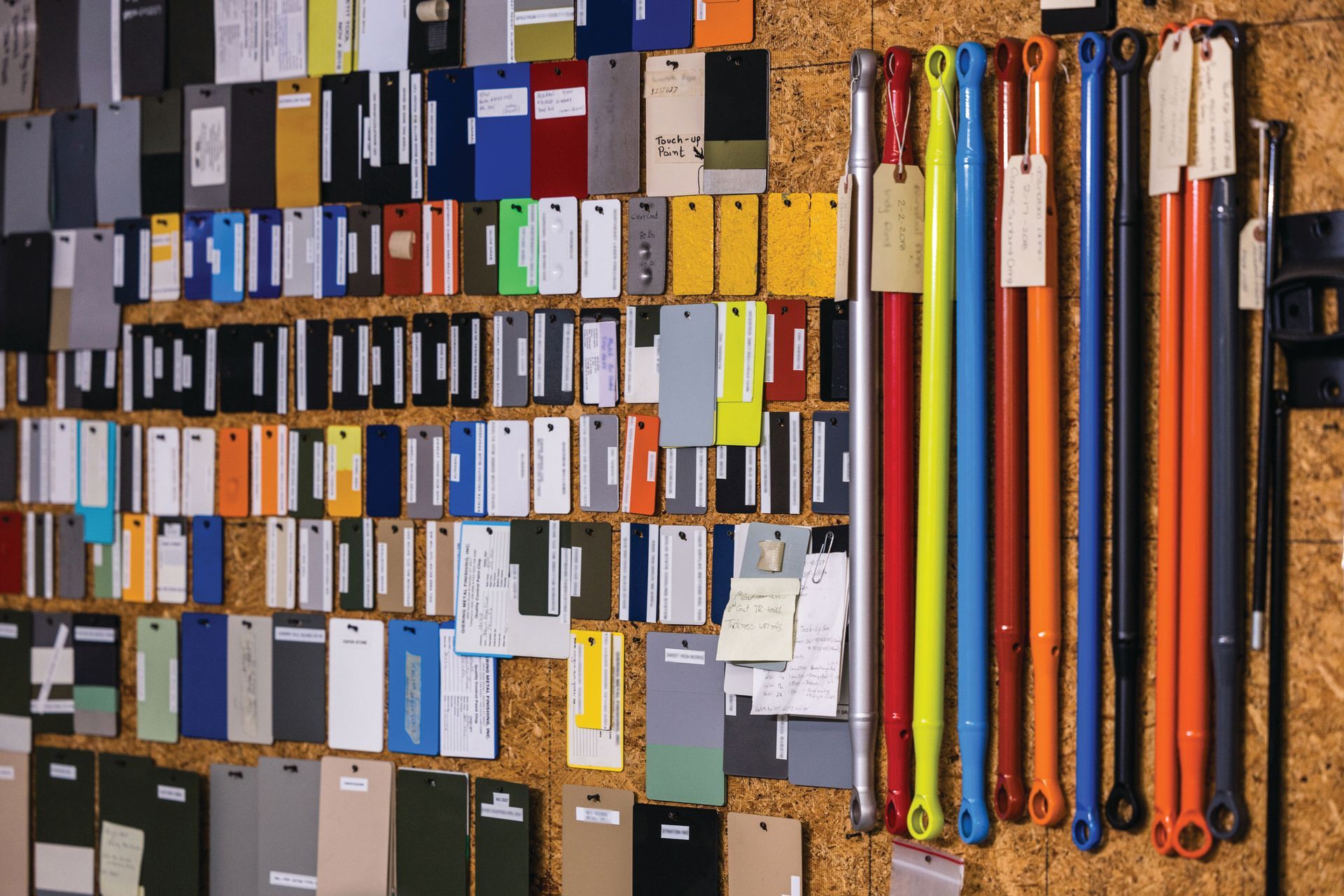 Wall of colorful ring binders and folders arranged in rows on shelves