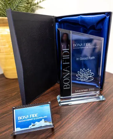 Glass award and business card in a presentation box, displaying 