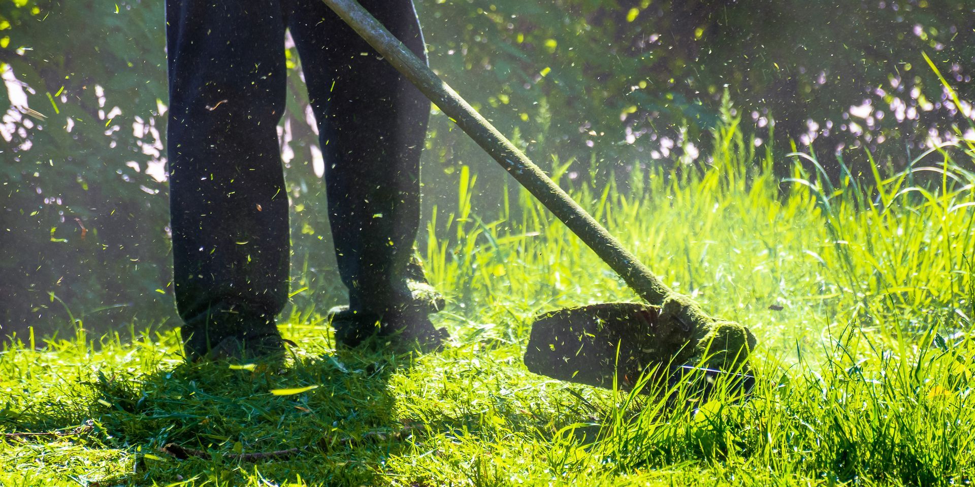 A man is cutting the lawn.