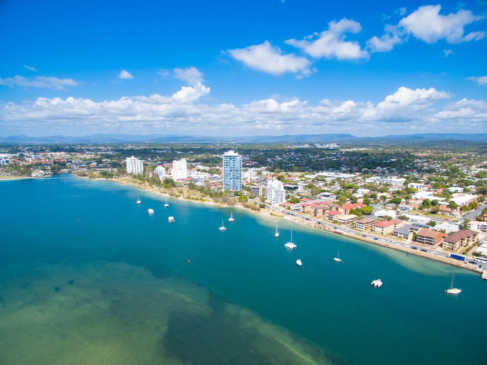 Aerial View of a Coastal City With Turquoise Water — Dent Motive In Burleigh Heads, QLD