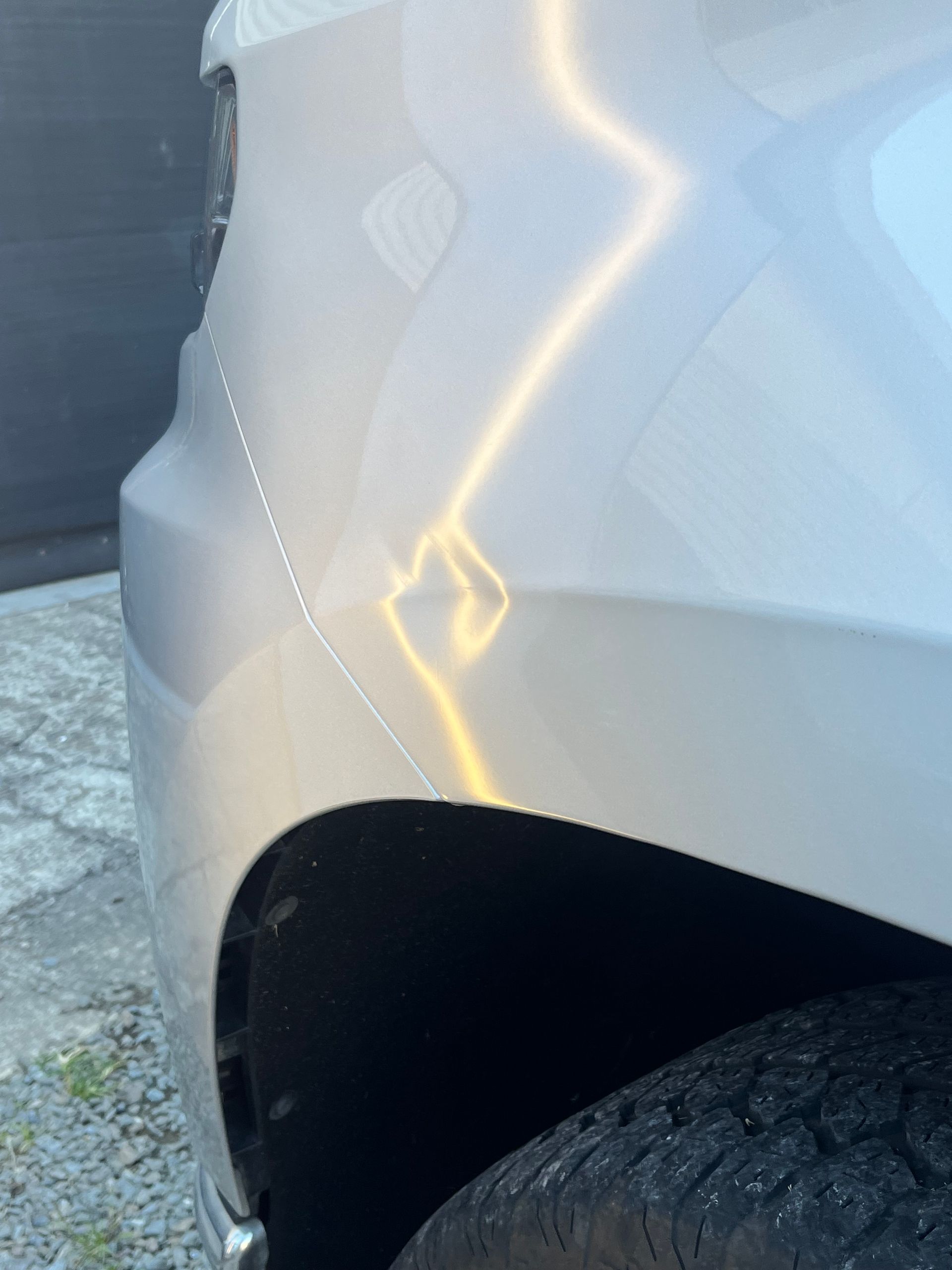 A close up of a car fender with a lightning bolt on it
