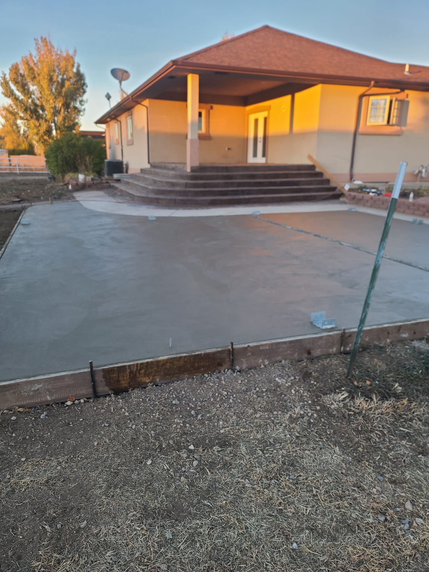 A large house with a concrete driveway in front of it.