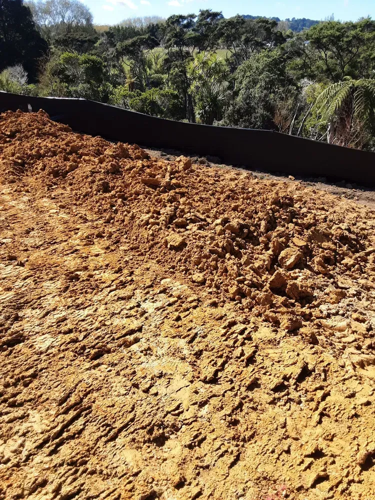 A large pile of dirt is sitting on top of a dirt field.