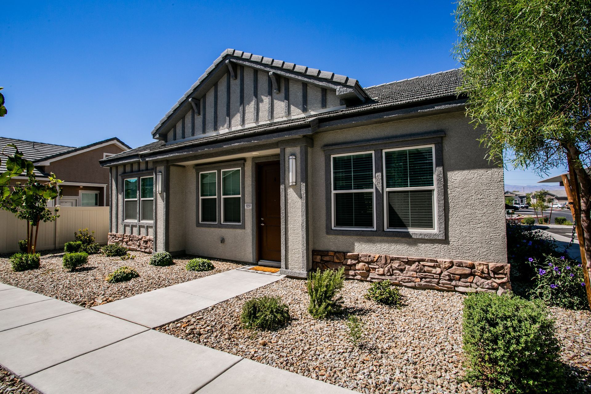 A house with a lot of windows and a walkway in front of it