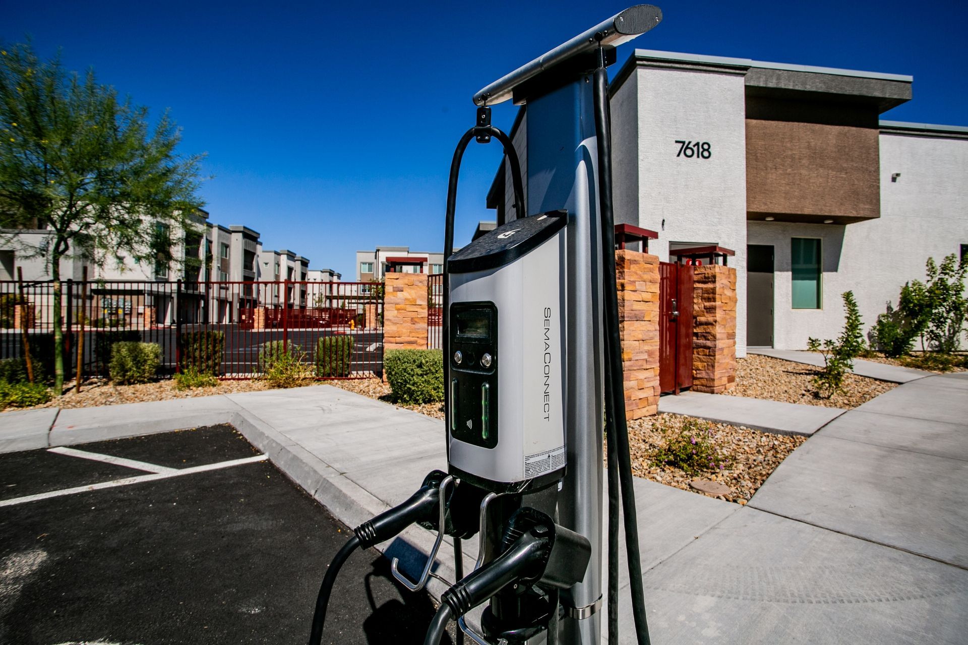 A charging station for electric cars is located in front of a building.