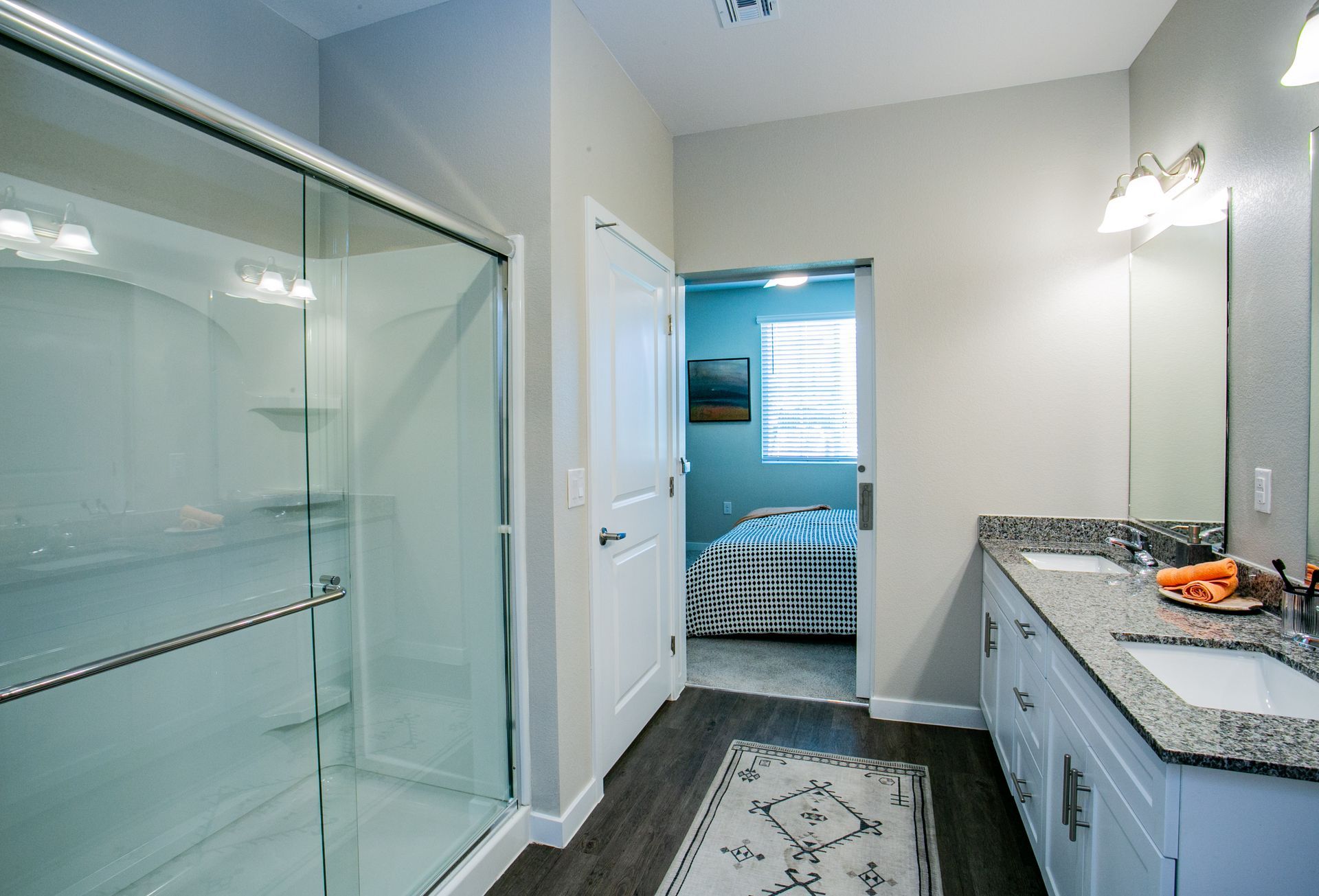A bathroom with a walk in shower , sink , and mirror.