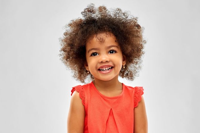 young girl with curly hair and pierced ears