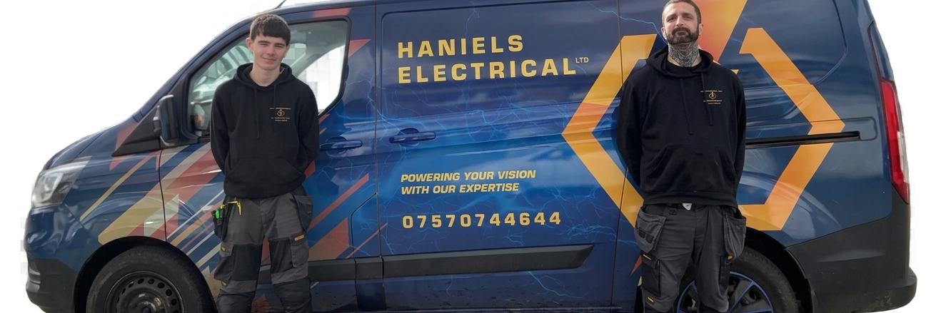 Two men standing beside a blue electrician van with yellow branding and contact details.