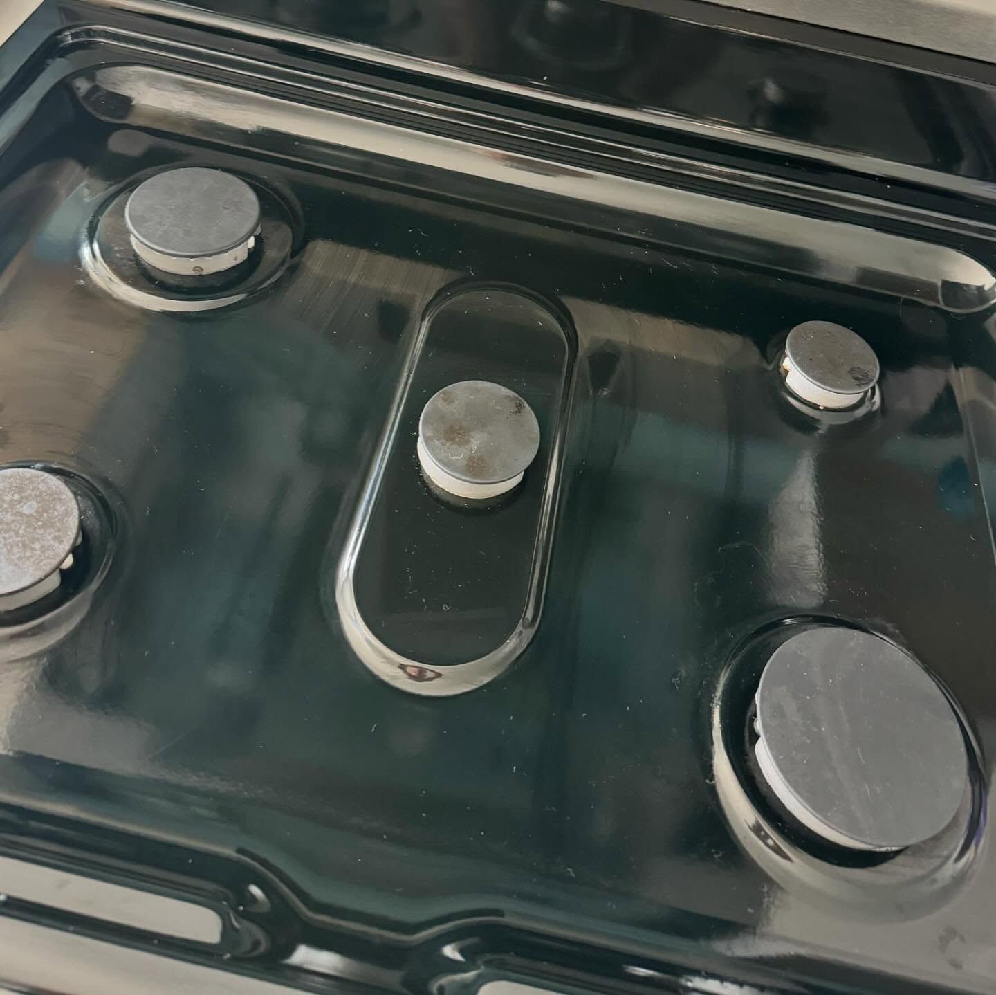 A close up of a gas stove with four burners