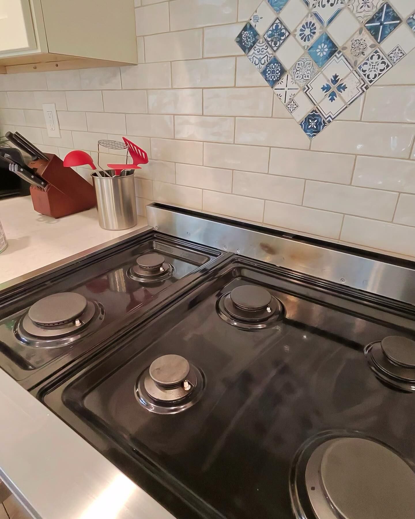 A stove top oven is sitting on top of a counter in a kitchen.