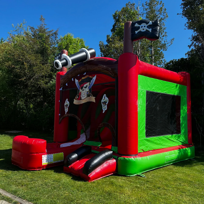 Inflatable boxing ring, red base, blue and yellow accents. Mesh sides allow visibility. Outdoors on grass. Inflatable boxing ring, red base, blue and yellow accents. Mesh sides allow visibility. Outdoors on grass.