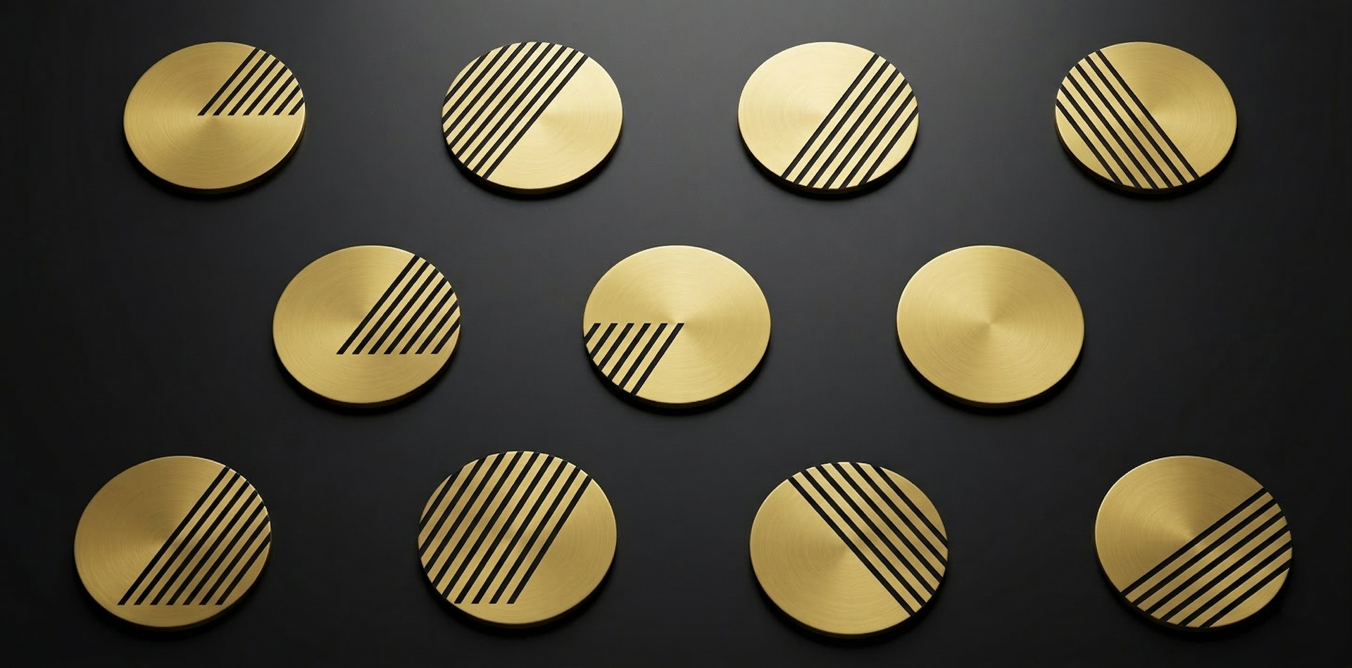 Eleven metallic gold circular discs arranged in rows, featuring various black-striped patterns on a dark background.