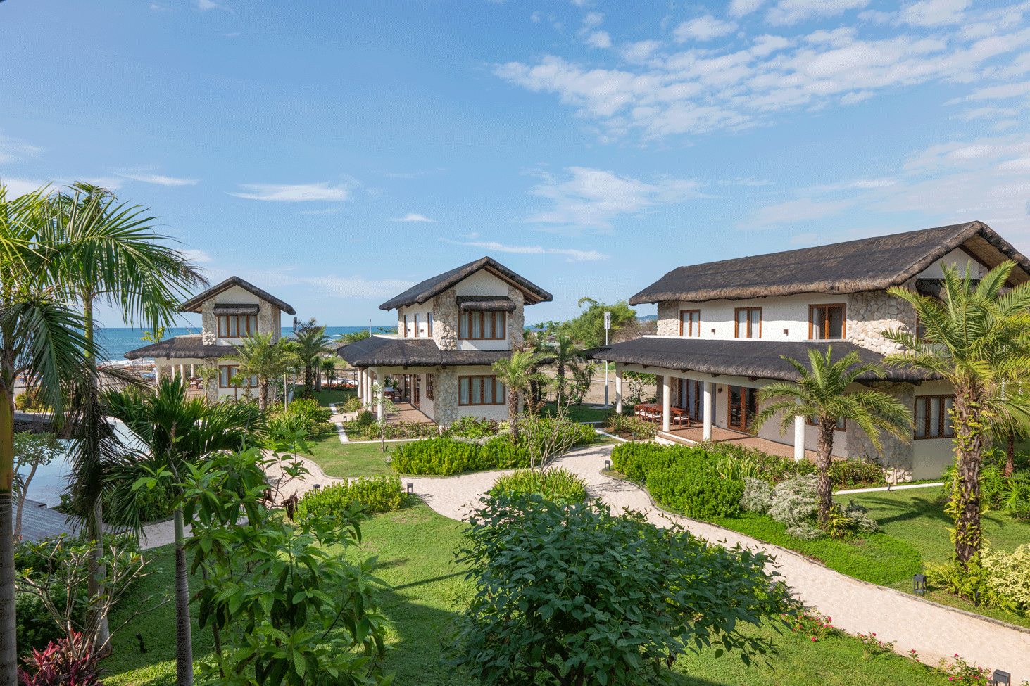 Harvest Hotel beachfront villas with thatched roofs and tropical gardens