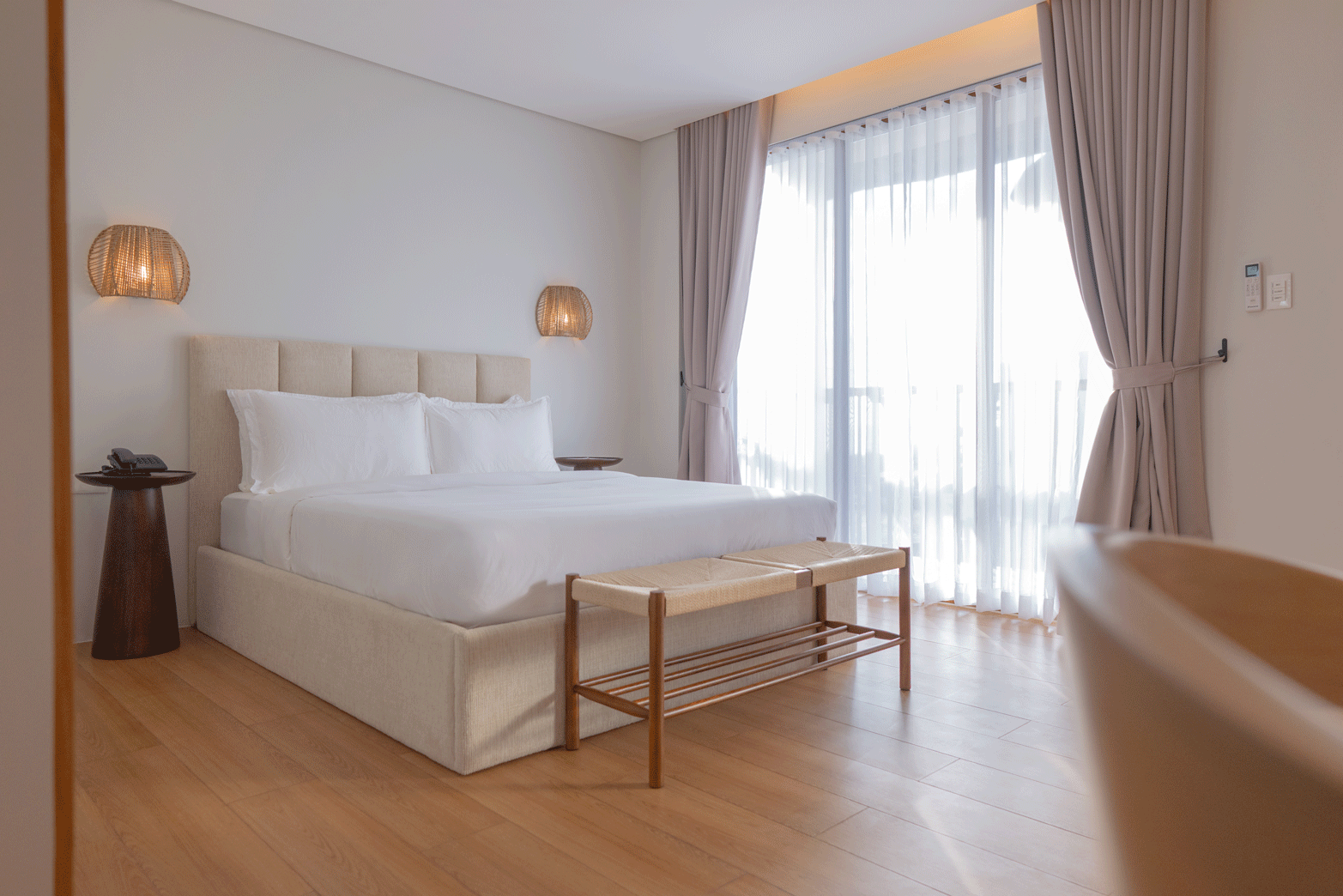 Bright minimalist hotel room with king bed at Harvest Hotel Cabanatuan