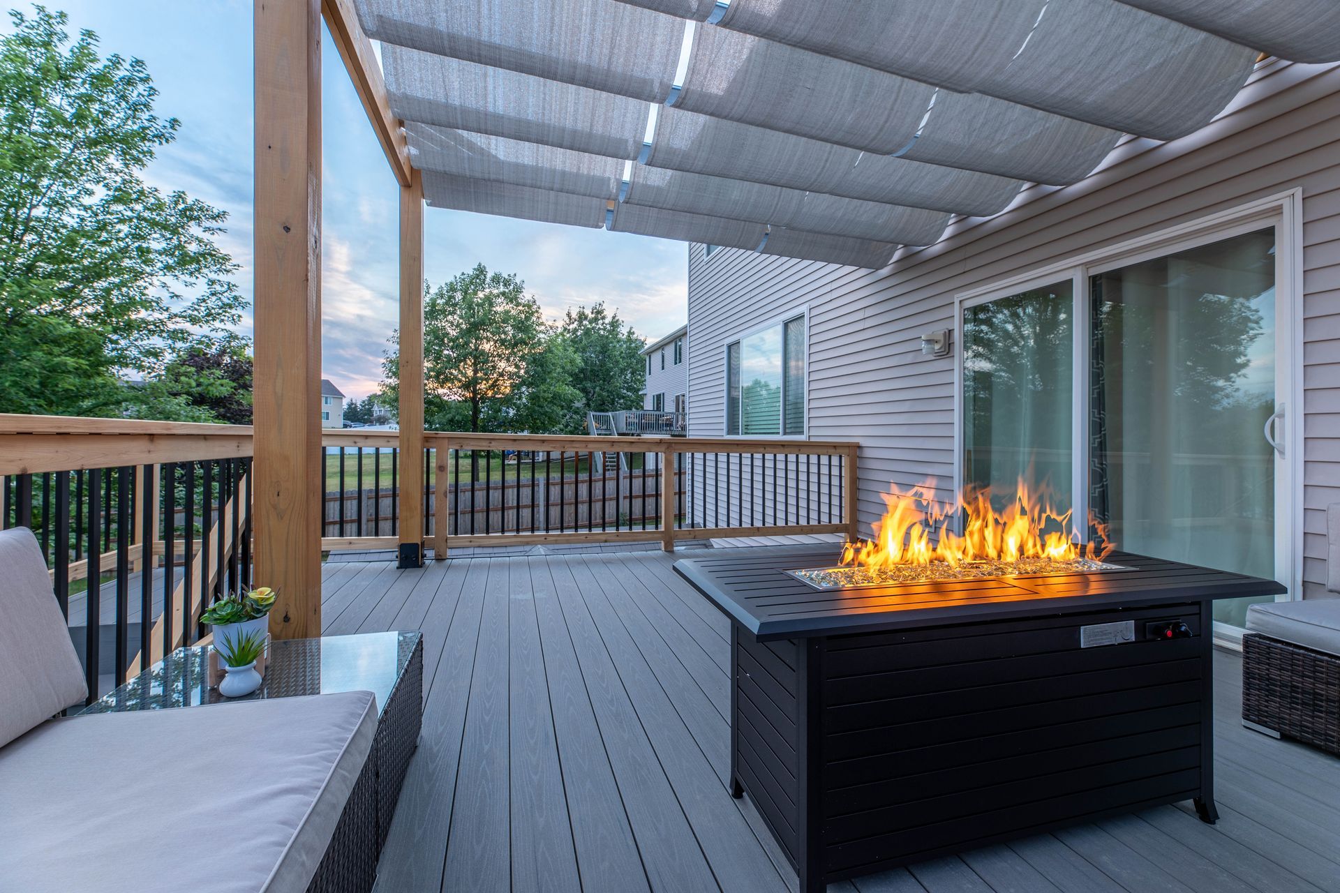There is a fire pit on the deck of a house.