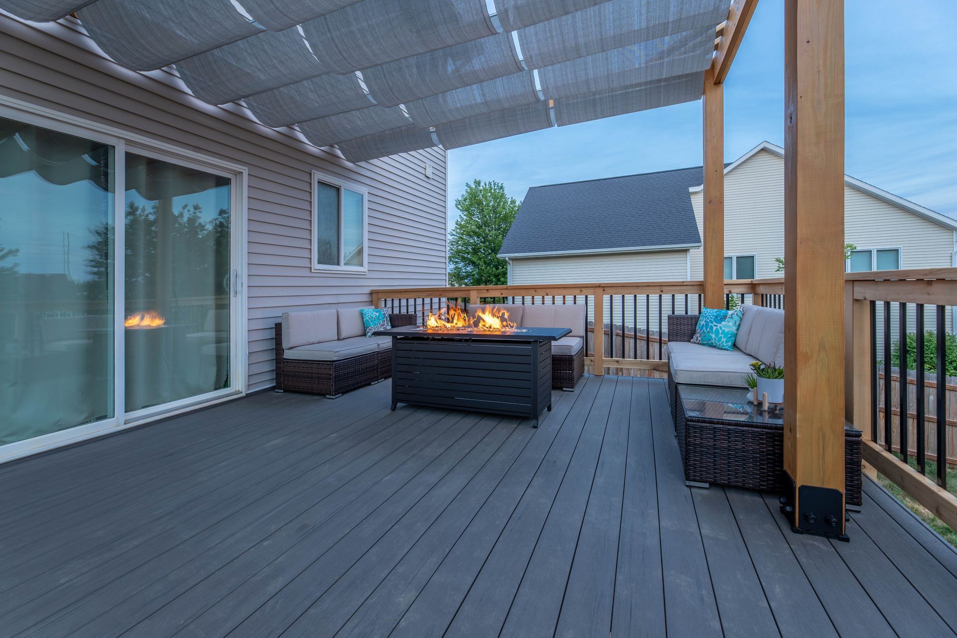 There is a fire pit on the deck of a house.