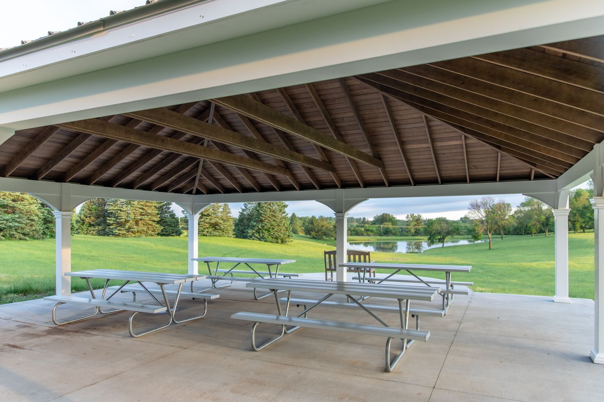 A pavilion with a lot of picnic tables underneath it