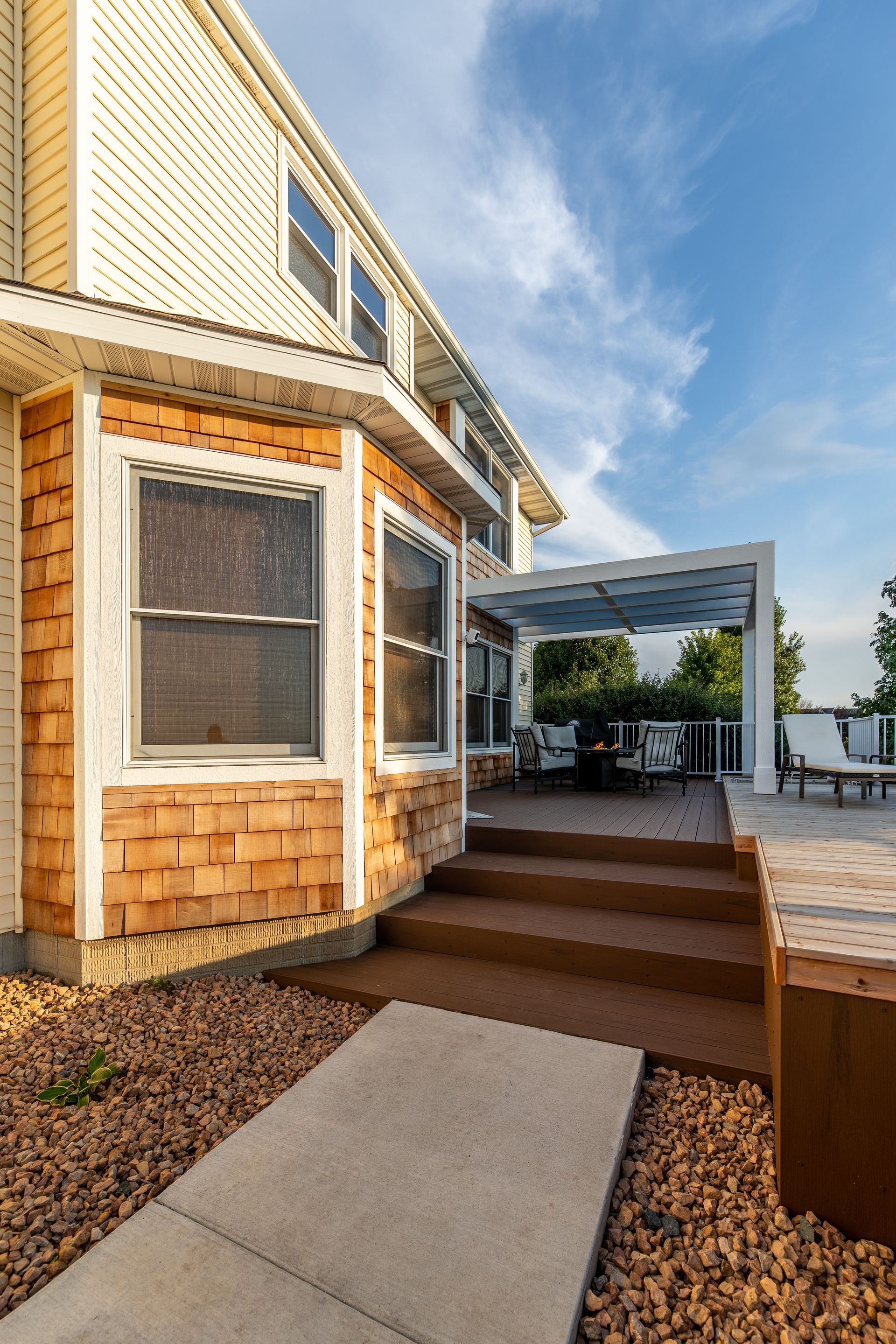 A large house with a large deck and stairs leading up to it.
