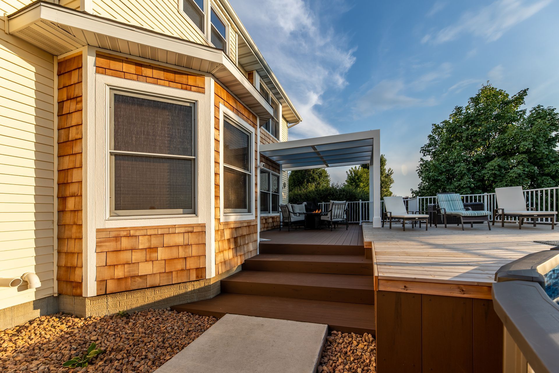 A house with a large deck and stairs leading to it.