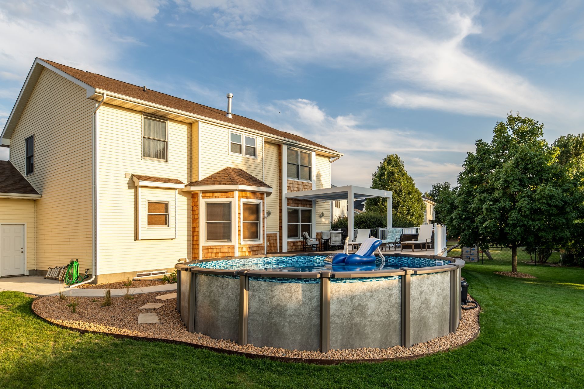 A large house with a swimming pool in front of it.