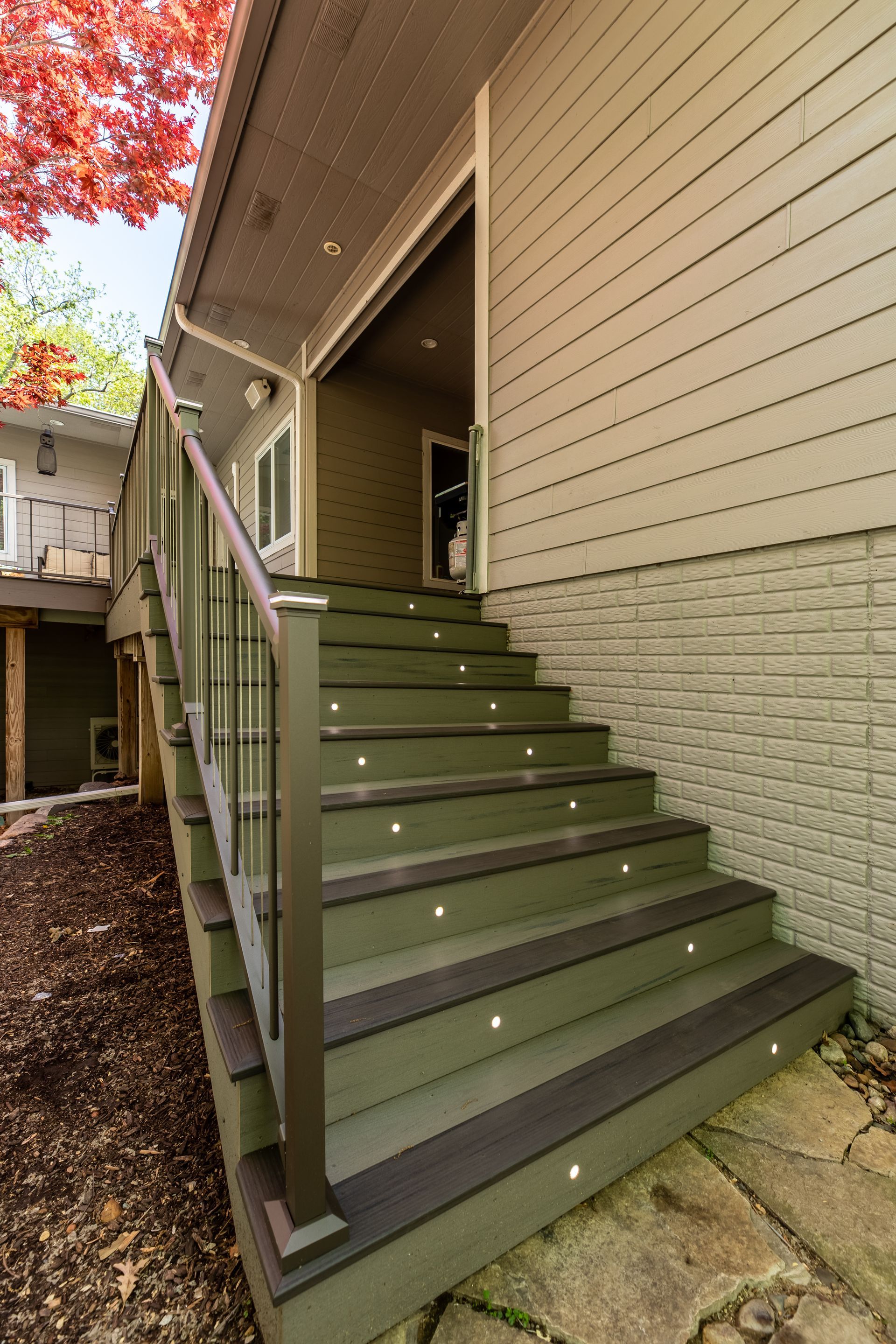 A set of stairs leading up to the front of a house.