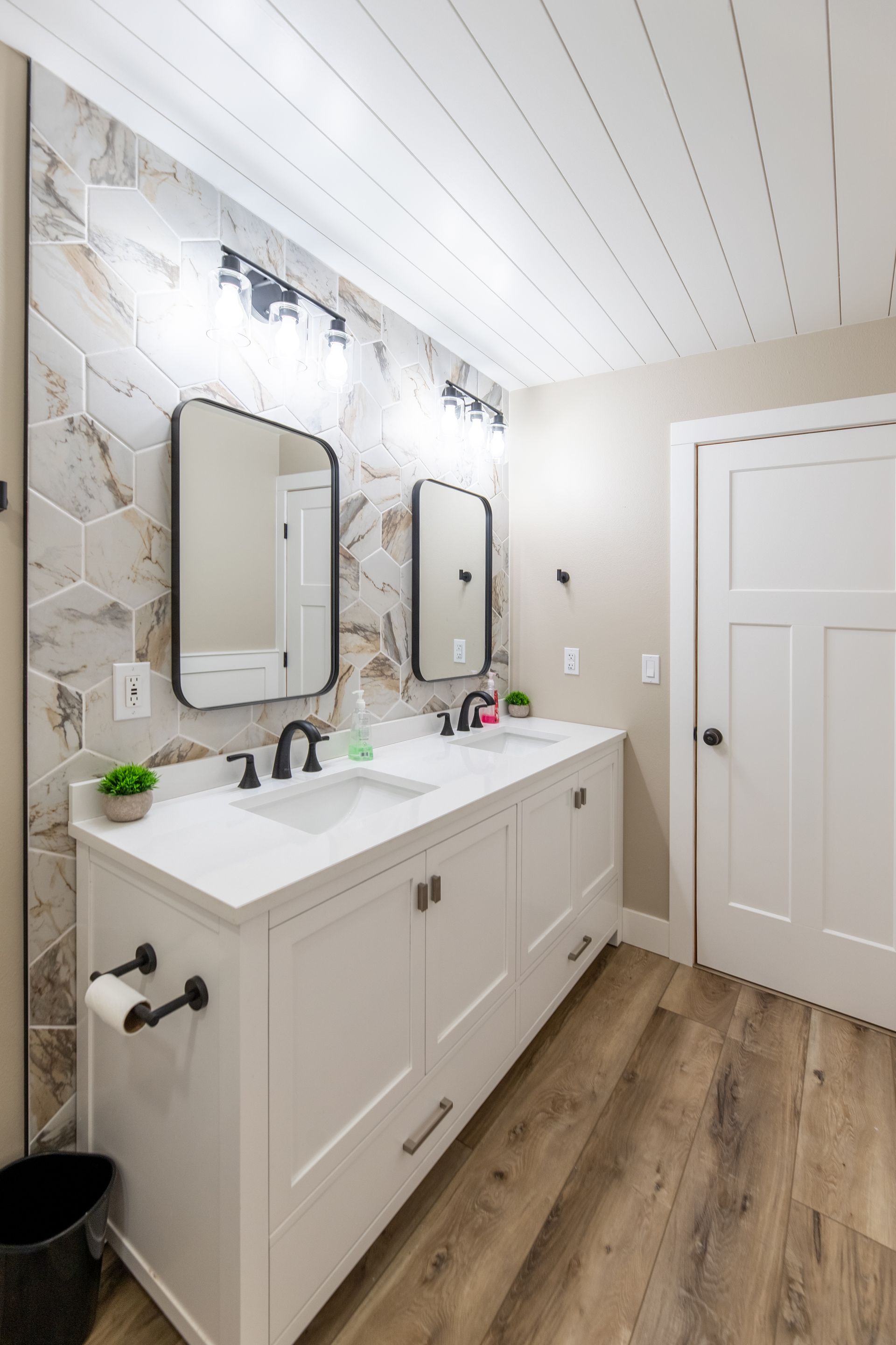 A bathroom with two sinks and two mirrors.