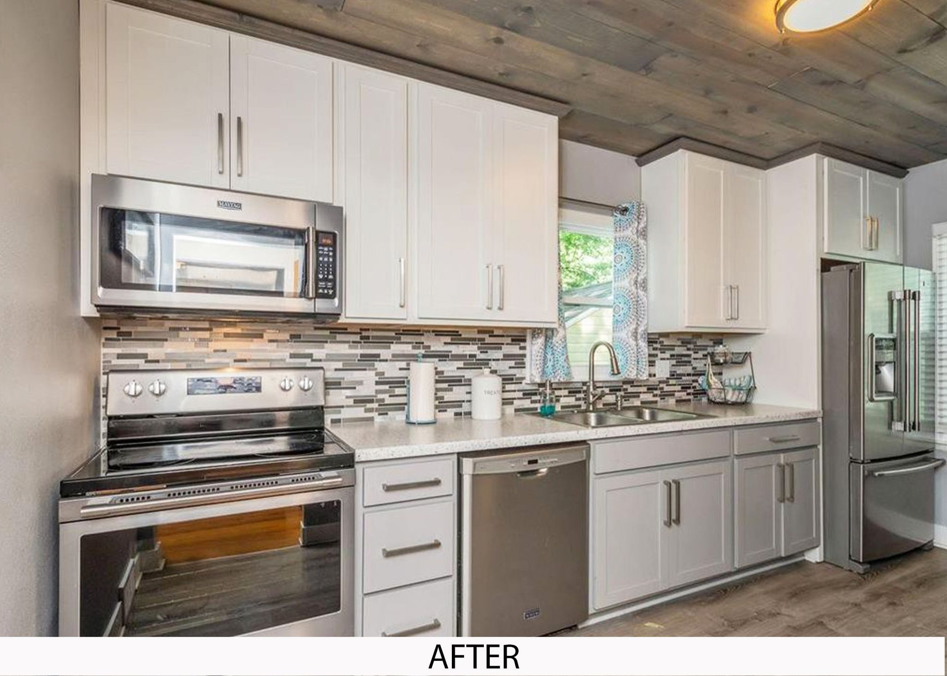 A kitchen with white cabinets and stainless steel appliances.