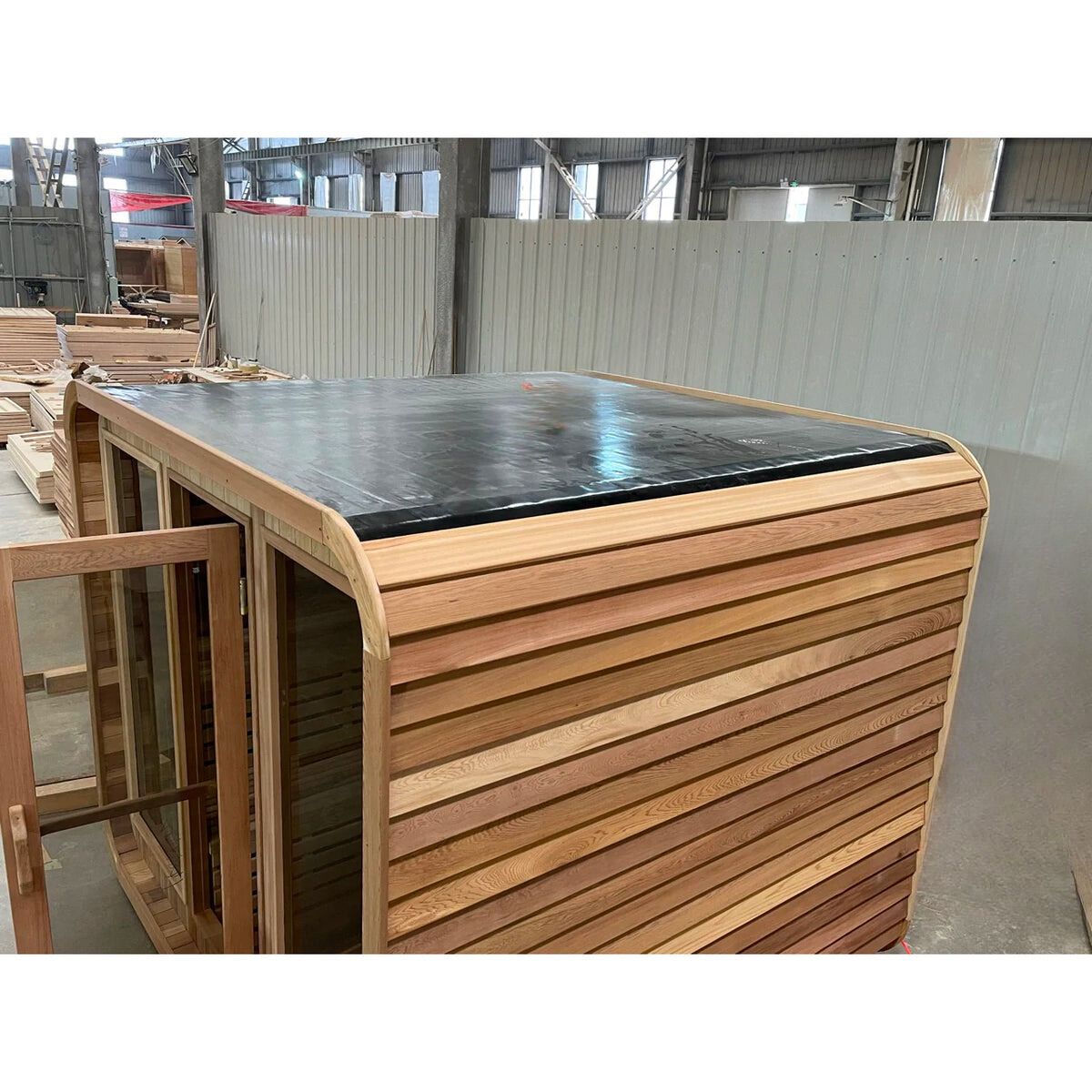 Wooden slatted cabinet or crate with a black top in a warehouse setting