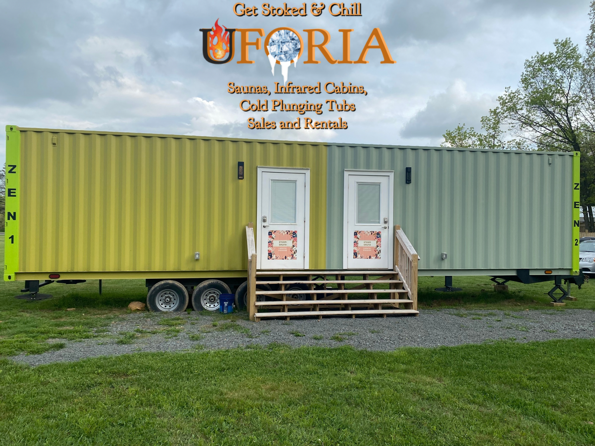 Portable patio-style food stand made from yellow and gray shipping containers on gravel, with a small porch and steps.