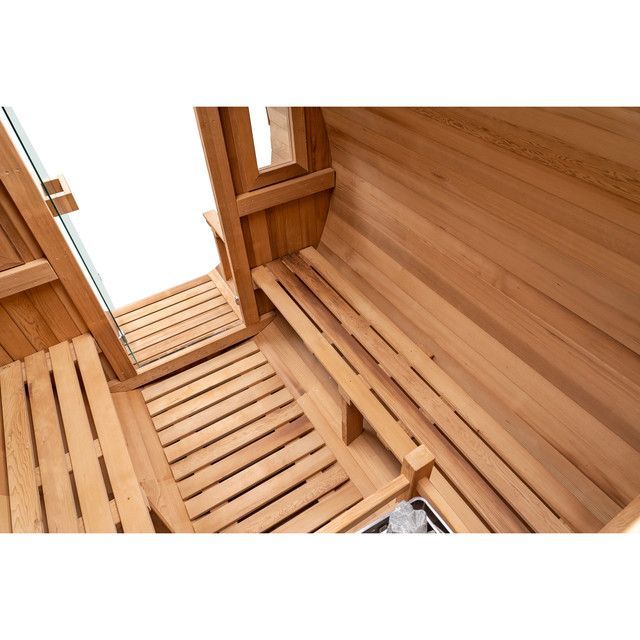 Wooden sauna interior with slatted benches and warm wood paneling