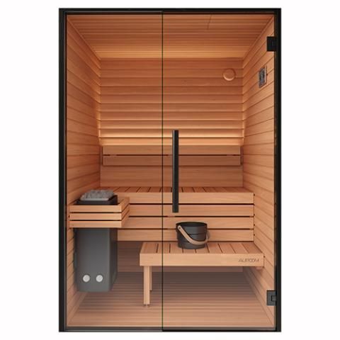 Small wooden outdoor sauna with glass door beside a modern house, surrounded by greenery.