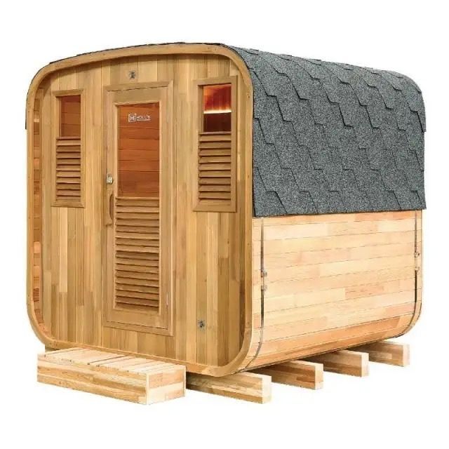 Wooden outdoor sauna with a gray shingled roof, shown on a pallet base.
