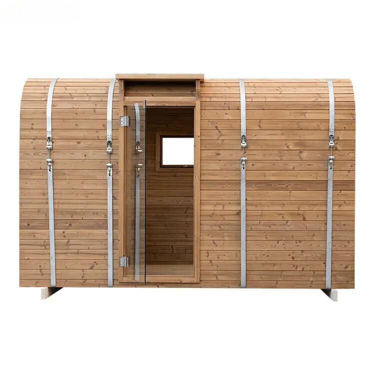 Wooden barrel-shaped sauna cabin with a small door and two windows