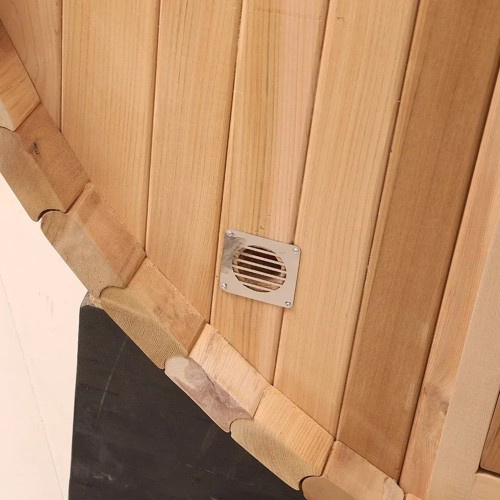 Close-up of a wood-paneled wall with a small square vent near the bottom edge